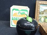 a picture of a black apple next to a picture of a green apple