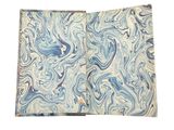 a close up of a blue and white marbled paper on a white background