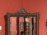 a mirror hanging on the wall next to a clock