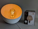 a light that is on in a bowl next to a box
