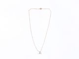 a white necklace with a small white diamond on a chain