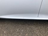 a close up of a car ' s bumper with the door open