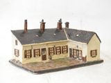 a small model of a house on a white surface