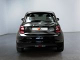 the back end of a small black car in a white room