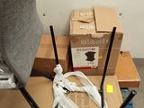 a stack of boxes and a chair on a pallet