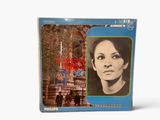 an old record with a picture of a woman in front of a building