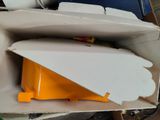 a cardboard box with a yellow object inside of it