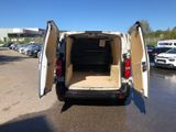 a white van with its doors open in a parking lot