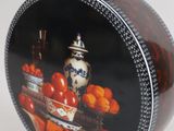 a black and white box with a picture of a bowl of oranges on it