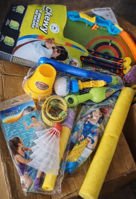 une boîte remplie de jouets et un livre posés sur une table