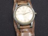 montre-bracelet avec bracelet en cuir marron sur fond noir