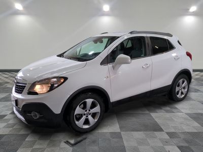 the white buick suv is parked on a checkered tile floor