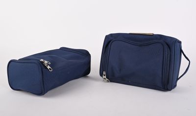 two pieces of luggage sitting on top of each other on a white surface