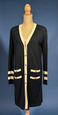a black and white cardigan sweater on a mannequin mannequin mannequin mannequin mannequin mannequin mannequin manne