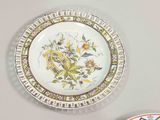 two plates on the wall with flowers painted on them