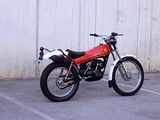 a red and black motorcycle parked in a parking lot