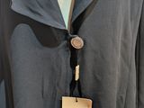 the back of a blue jacket with a white tag on it