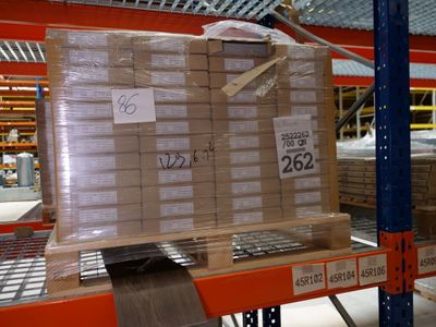 boxes are stacked on a pallet in a warehouse with a price tag on it