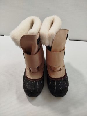 une paire de bottes d'hiver pour enfants posée sur une surface blanche