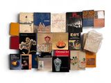 a lot of books that are on a white surface