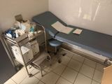 a hospital room with a bed and a chair in it