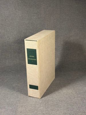 an old book sitting on top of a table next to a gray background