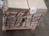 several stacks of wood stacked on top of each other in a warehouse