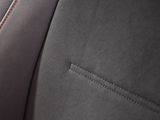 the interior of a car with a red stitching on the front seat