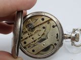 a close up of a pocket watch being held by a person