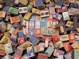 a pile of old matchboxes sitting on a table