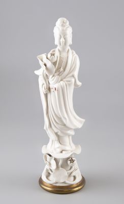 une statue blanche représentant une femme tenant une fleur, posée sur un socle doré