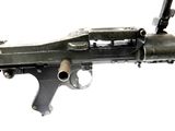 a machine gun that is on display on a white background
