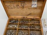 a wooden box filled with lots of different types of jewelry