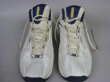 pair of white sneakers with blue and yellow stripes on them