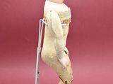 a figurine of a baby with crutches on it ' s legs