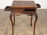 a small wooden table with a drawer on top of it