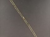 a close up of a necklace on a table with a price tag