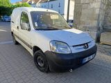 a small white van parked on the side of the road