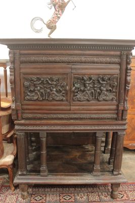 une armoire en bois ornée de sculptures sur le dessus