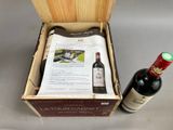 two bottles of wine and a newspaper in a wooden box