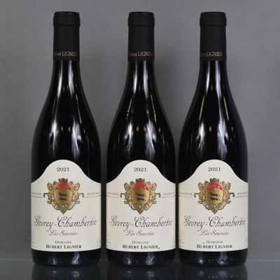 three bottles of wine are lined up on a table