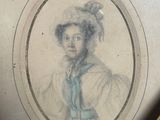 an old picture of a woman with a blue tie in a gold frame