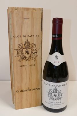a bottle of wine sitting next to a wooden box