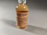 a small bottle of liquid sitting on a table