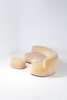 une image représentant une chaise et un pouf dans une pièce aux murs blancs