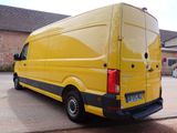 a yellow van that is parked in a parking lot