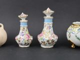 three vases are sitting next to each other on a black surface