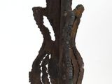 a large metal vase that is standing on a stand
