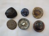 five different types of buttons on a white surface