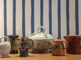 many different types of mugs sitting on a table